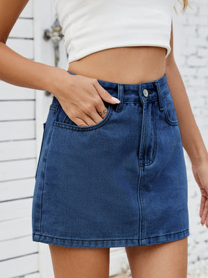 Classic denim mini skirt in medium wash with front pockets and button closure.
