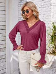 Lace trim V-neck blouse in a deep pink with blouson sleeves and smocked cuffs.
