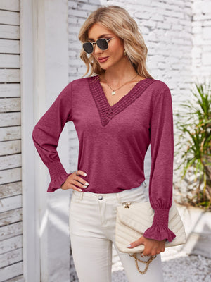 Lace trim V-neck blouse in a deep pink with blouson sleeves and smocked cuffs.