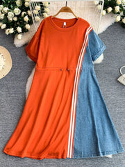 Orange red and denim color block casual dress with drawstring waist and white stripes.