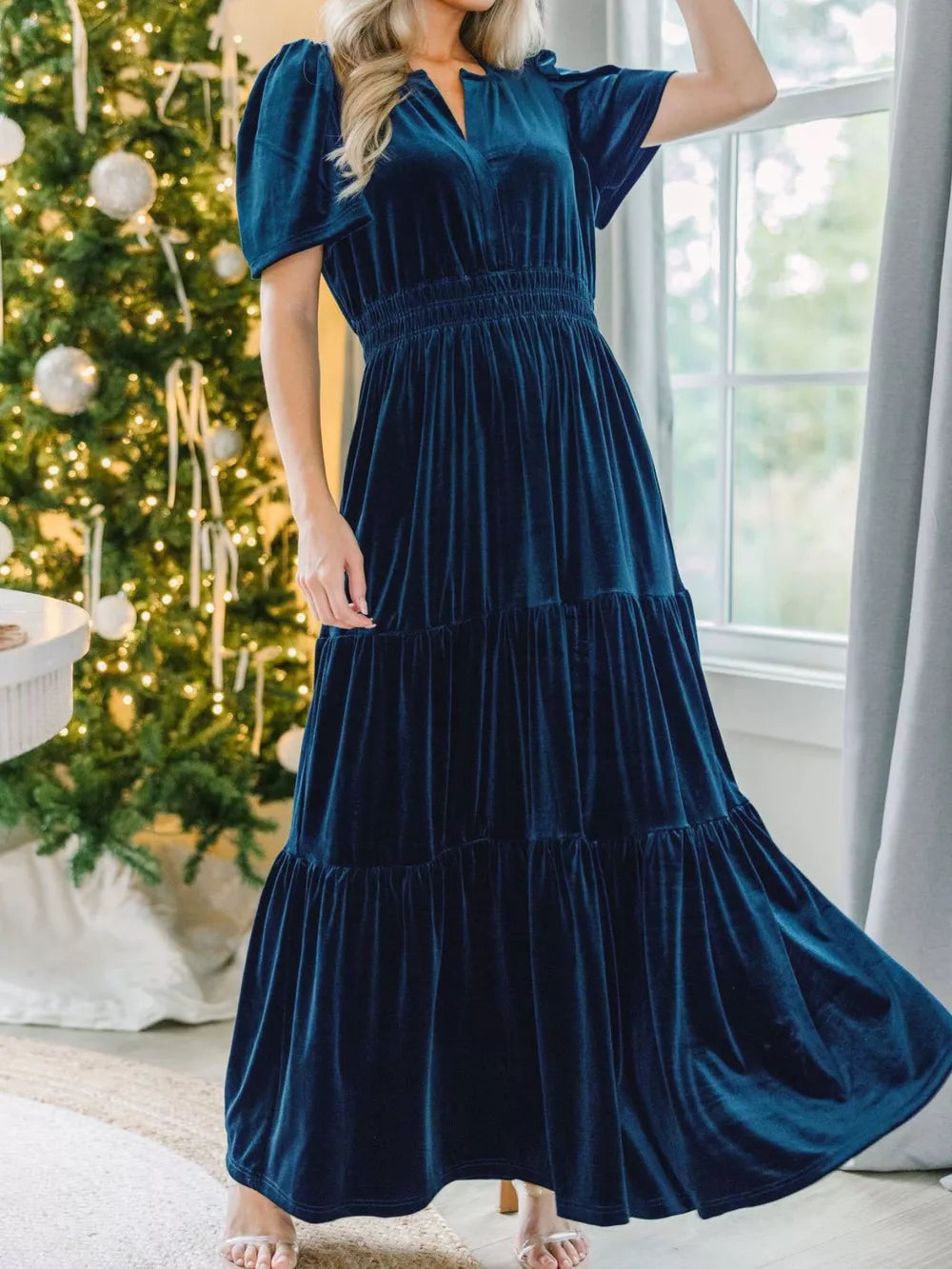 Navy blue velvet maxi dress with tiered skirt and short sleeves.