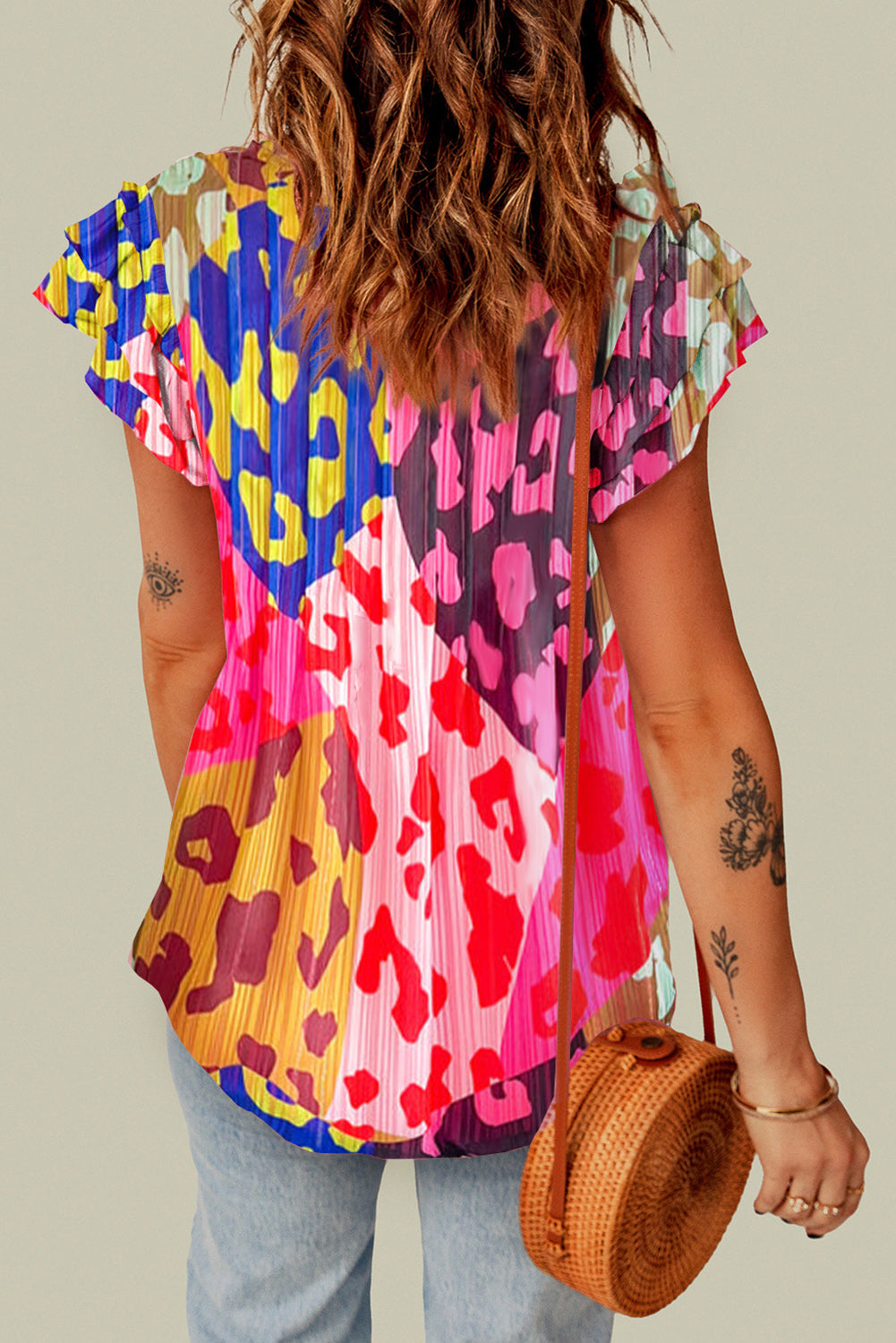Blouse with ruffle sleeves and a colorful patchwork animal print.