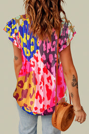 Blouse with ruffle sleeves and a colorful patchwork animal print.