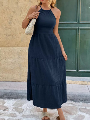 Navy ruched halter midi dress with tiered skirt and tie back detail.