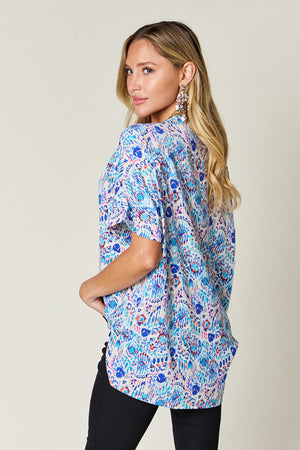 Floral ikat relaxed v-neck blouse in sky blue with short sleeves.