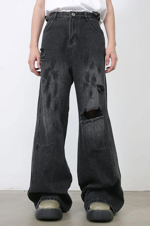 Dark relaxed fit denim jeans with distressed rips and wide leg
