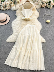 White eyelet maxi skirt and ruffled crop top set with elastic waistband.