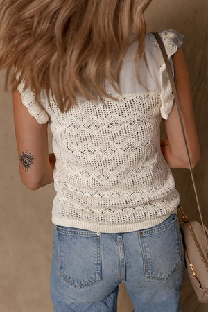 Beige crochet knit vest with eyelet yoke detail and ruffled cap sleeves.