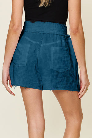 Textured gauze shorts in dark blue with drawstring waist and frayed hem.