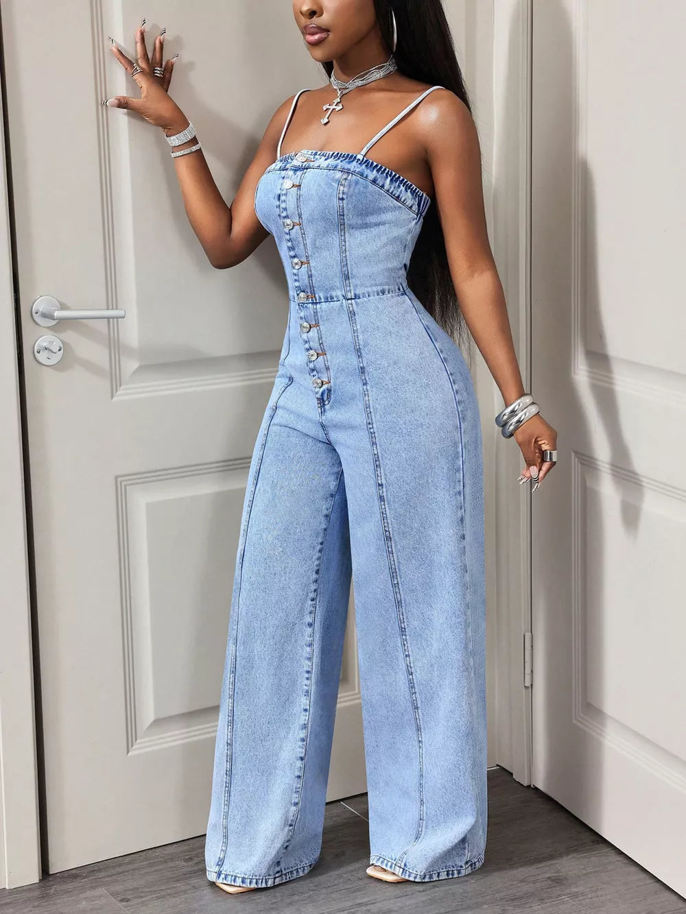Light wash denim jumpsuit with button-down front and wide legs.
