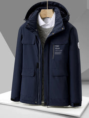 Navy hooded puffer jacket with chest graphic and multiple pockets.