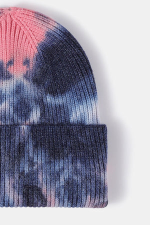 Ribbed knit beanie with sunset dip-dye pattern in navy and pink.