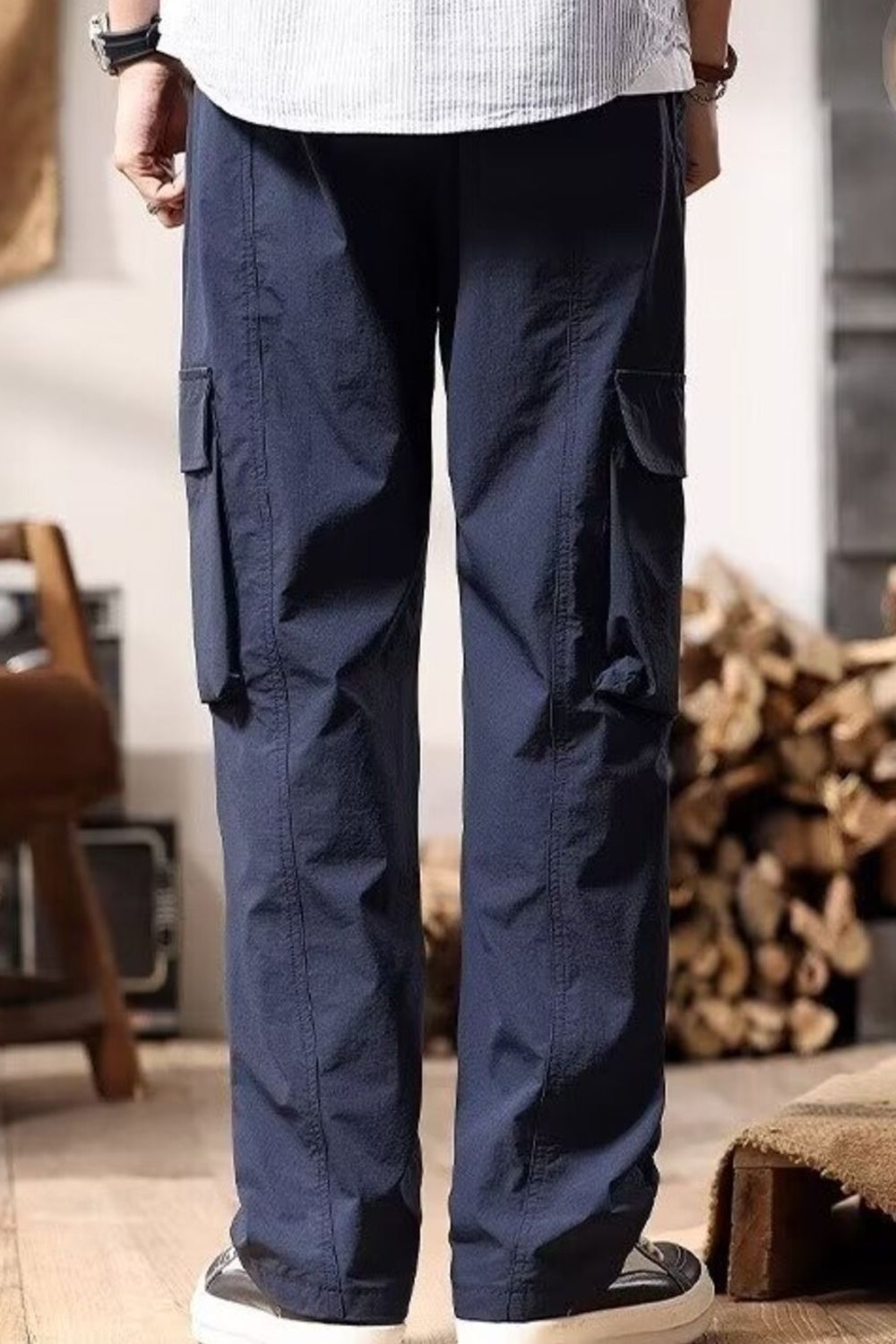 Navy cargo pants with drawstring and multiple pockets.