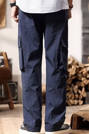 Navy cargo pants with drawstring and multiple pockets.