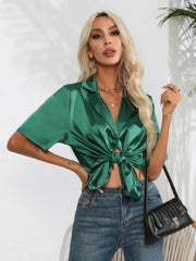 Dark green satin tie-front collared shirt with short sleeves and a knotted hem.