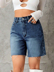 High-waisted denim bermuda shorts in medium blue with frayed hem.