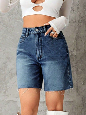 High-waisted denim bermuda shorts in medium blue with frayed hem.