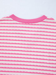 Textured pink and white striped t-shirt with a V-neck and ribbed collar.