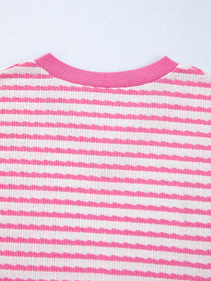 Textured pink and white striped t-shirt with a V-neck and ribbed collar.