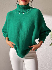 Green knit sweater with dolman sleeves, turtleneck, and pearl embellishments.