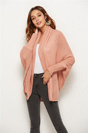 Textured cocoon knit cardigan in blush pink with batwing sleeves and open front.