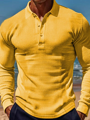 Gold textured waffle knit long-sleeve polo shirt with a buttoned collar.