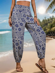 Bohemian harem trousers in dusty blue with medallion print and elastic cuffs.