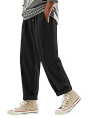 Men's black loose fit drawstring sweatpants with cuffed hems.