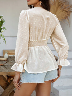 Tan Swiss dot blouse with smocked waist and ruffled cuffs.