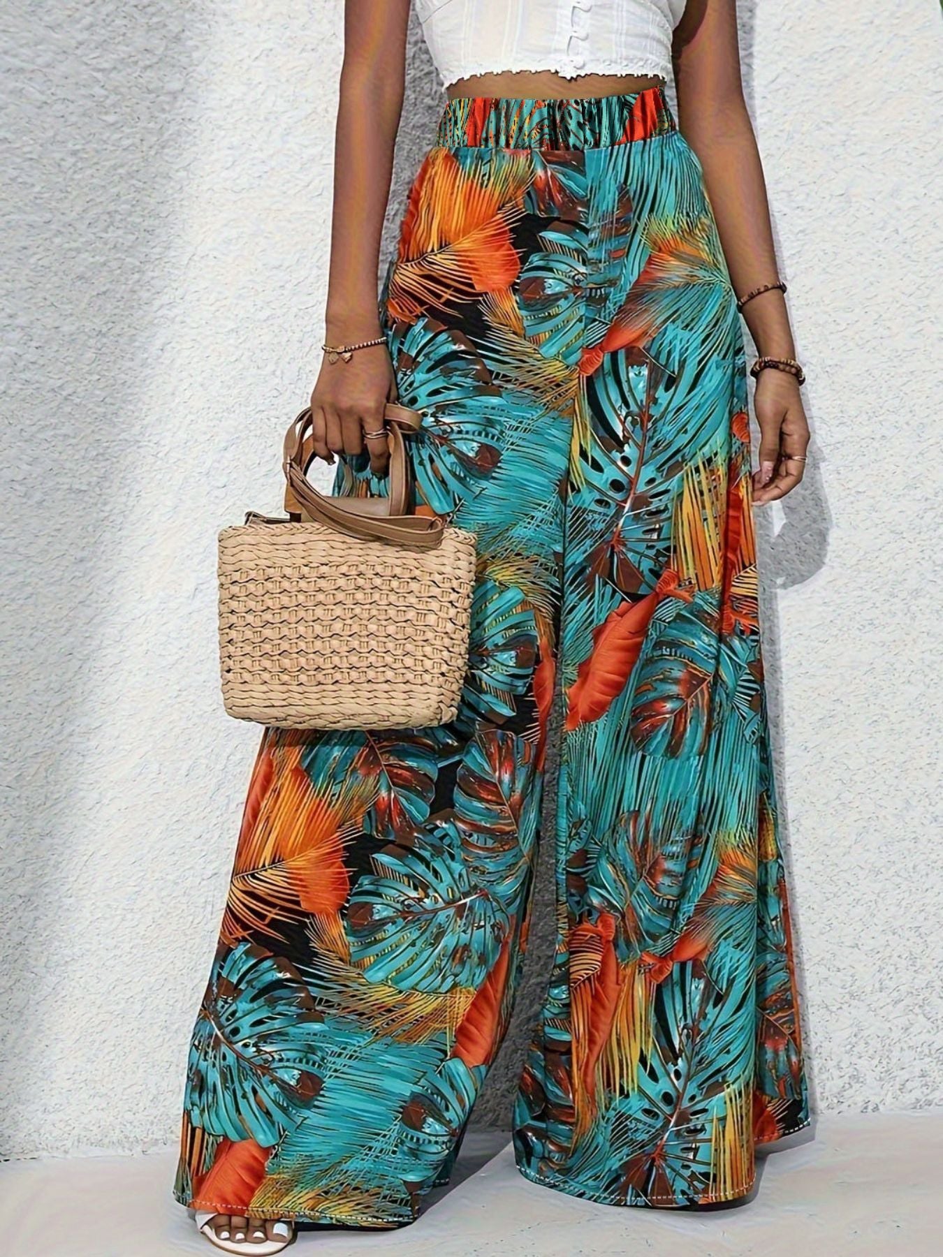 Tropical print wide leg pants with elastic waistband and flowy cut.