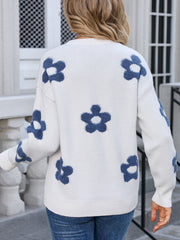 White crewneck knit sweater with blue floral appliqué pattern