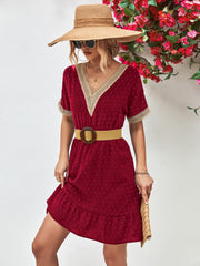 Burgundy Swiss dot dress with crochet trim and ruffle hem, V-neck, short sleeves.