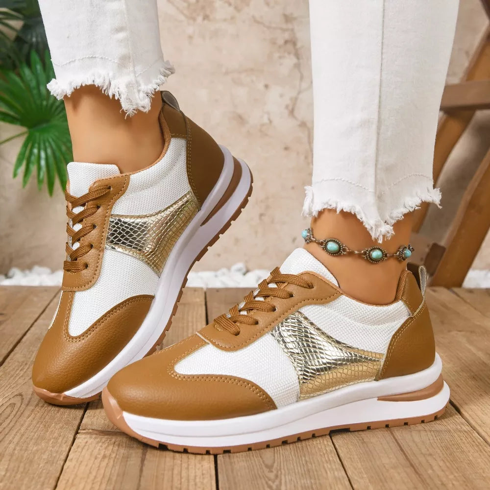 Chic lace-up sneakers in light brown and white with textured gold accents.