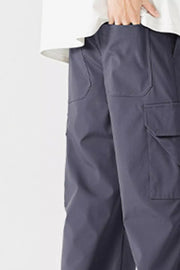Men's dark gray cargo pants with multiple pockets and a relaxed fit.