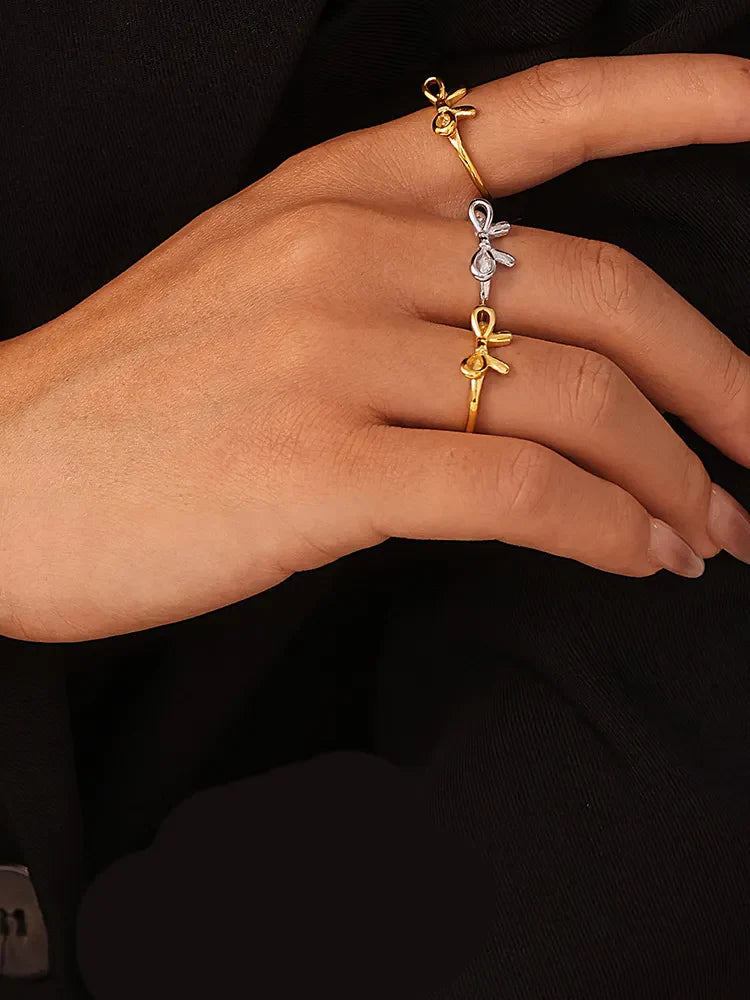 Delicate bow contour rings in gold and silver, 18K gold-plated.