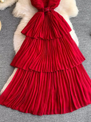 Red belted midi dress with tiered pleated skirt and spaghetti straps.
