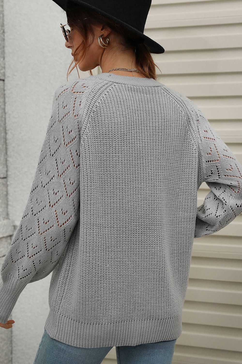 Gray acrylic diamond knit cardigan with openwork sleeves and crew neck.
