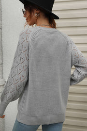 Gray acrylic diamond knit cardigan with openwork sleeves and crew neck.