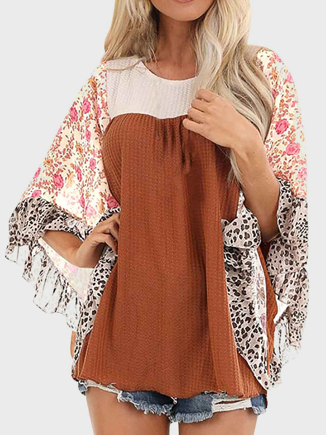 Textured panel blouse with floral and leopard print flutter sleeves.