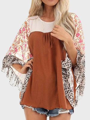 Textured panel blouse with floral and leopard print flutter sleeves.