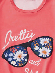 Coral graphic tee with floral sunglasses print and text.