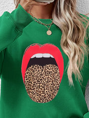 Green sweatshirt with a bold red lips and leopard tongue graphic.