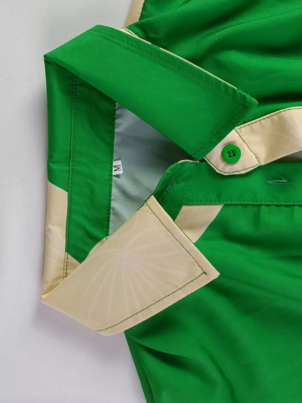 Green abstract print belted shirt dress with collared neckline and button details.