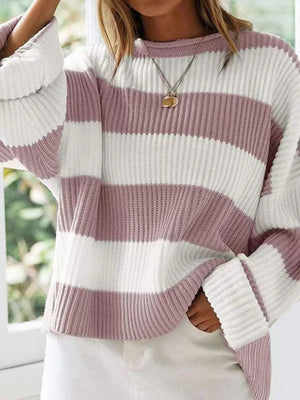 Striped oversized knit sweater in dusty pink and white with bell sleeves and a crew neck.