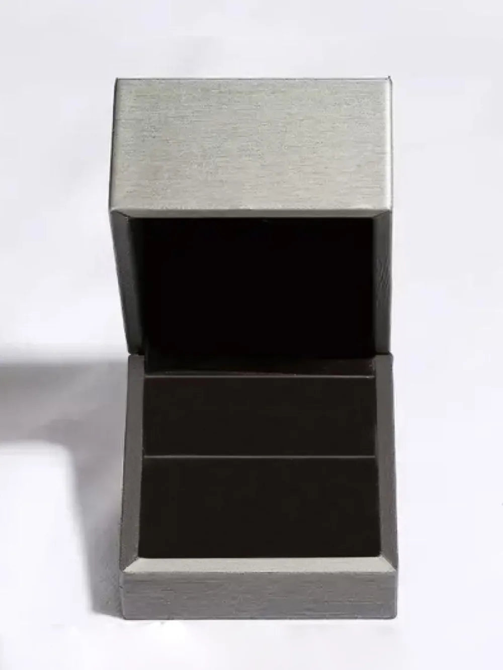 Prismatic Teal Statement Ring presentation box open, showing dark interior.