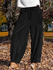 Black corduroy wide-leg pants with pockets and drawstring waist.