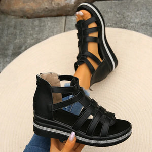 Black gladiator wedge sandals with crystal trim and side zipper.