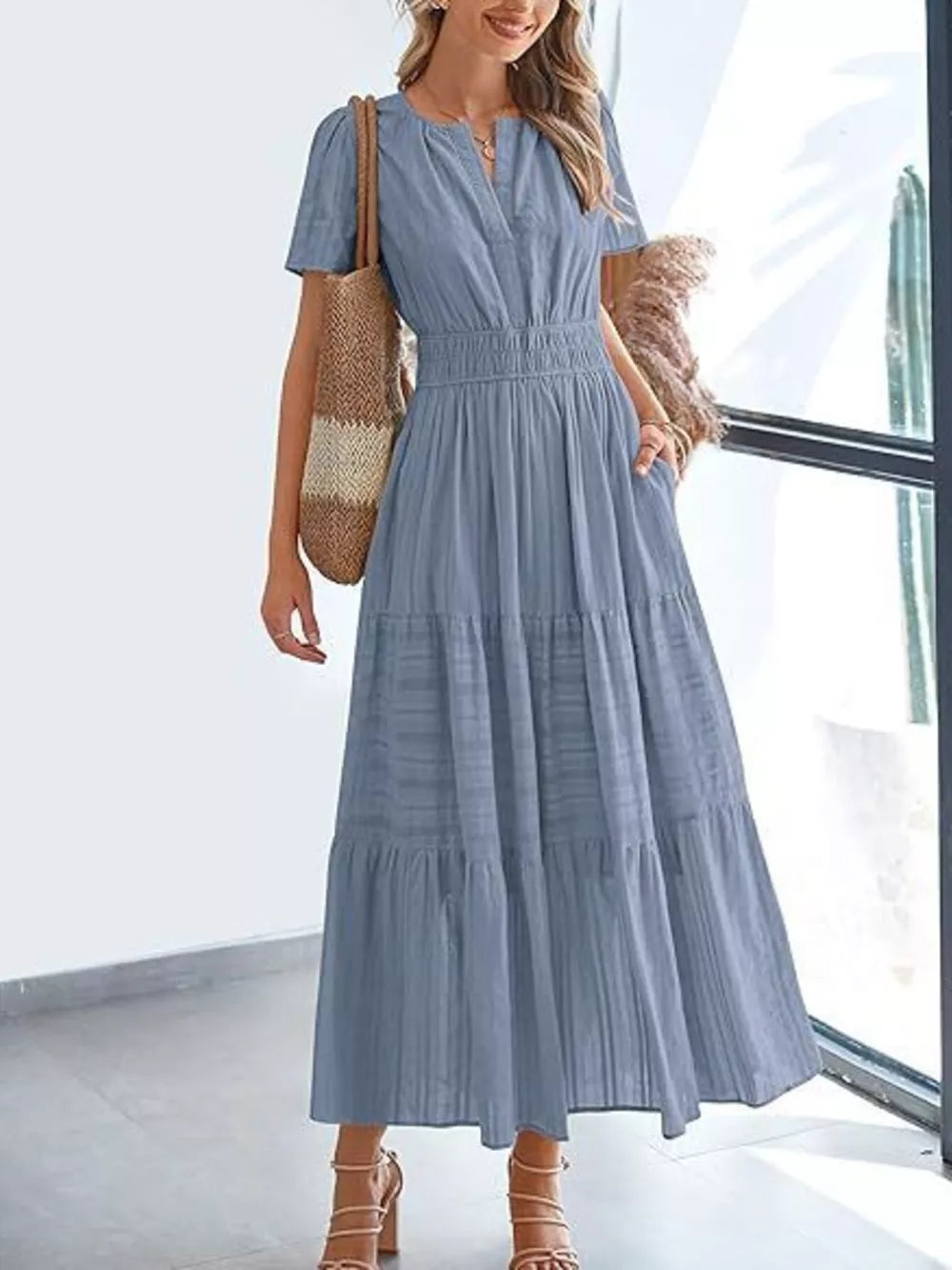 Light blue ruched V-neck tiered midi dress with short sleeves and pockets.