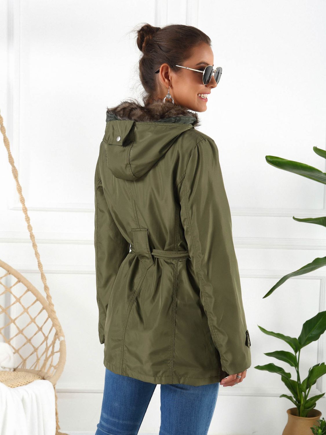 Belted utility parka in army green with faux fur hood trim and a cinched waist.