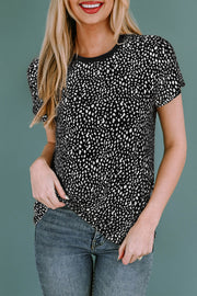 Black spotted print crew neck t-shirt with short sleeves, styled with blue jeans.